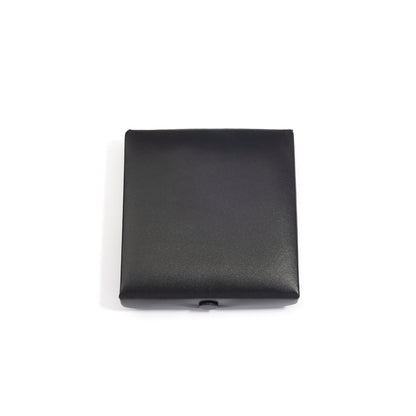 A closed black medium square jewelry box with a smooth surface, viewed from above