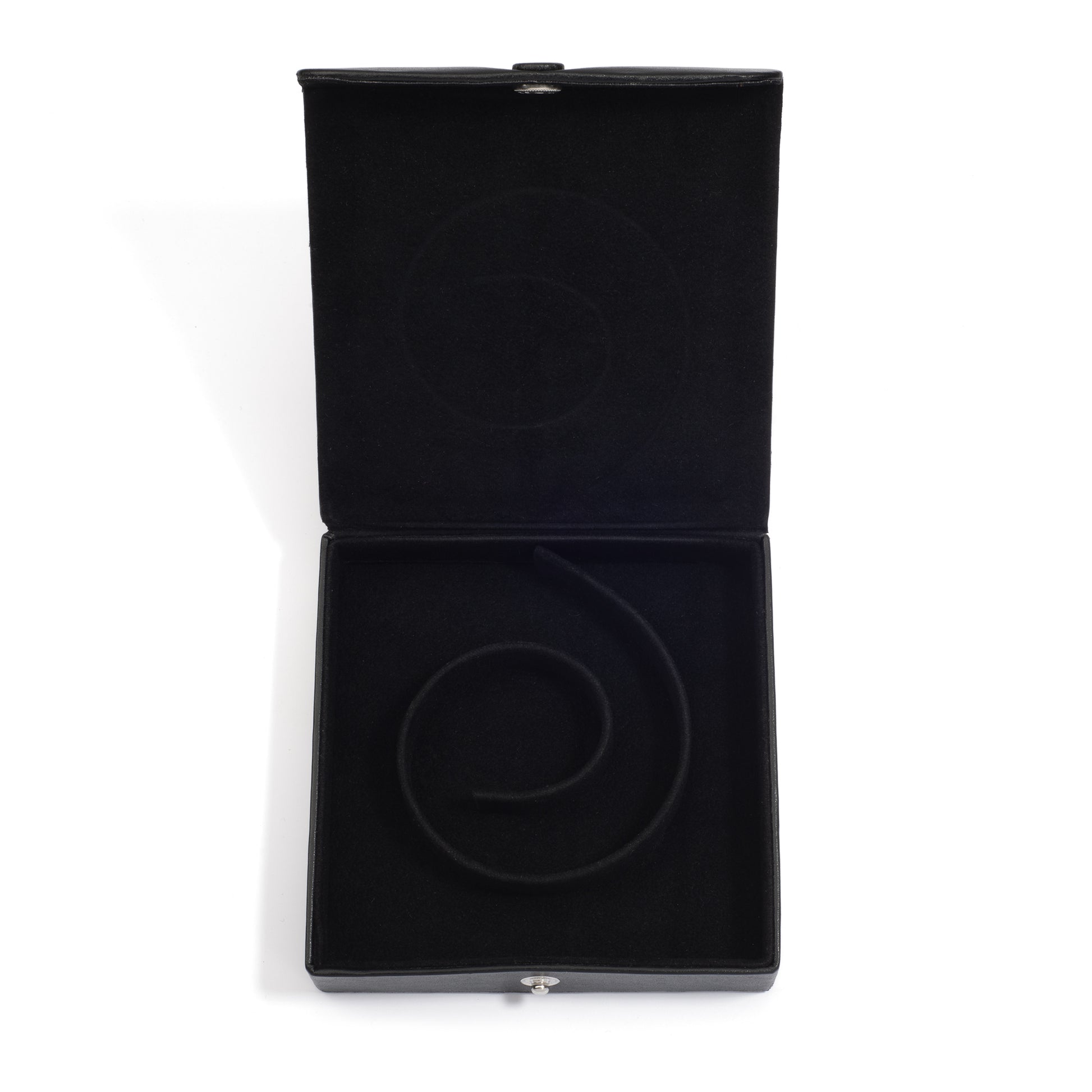 An open black medium jewelry box with a spiral groove inside, designed to hold a pearl coil necklace