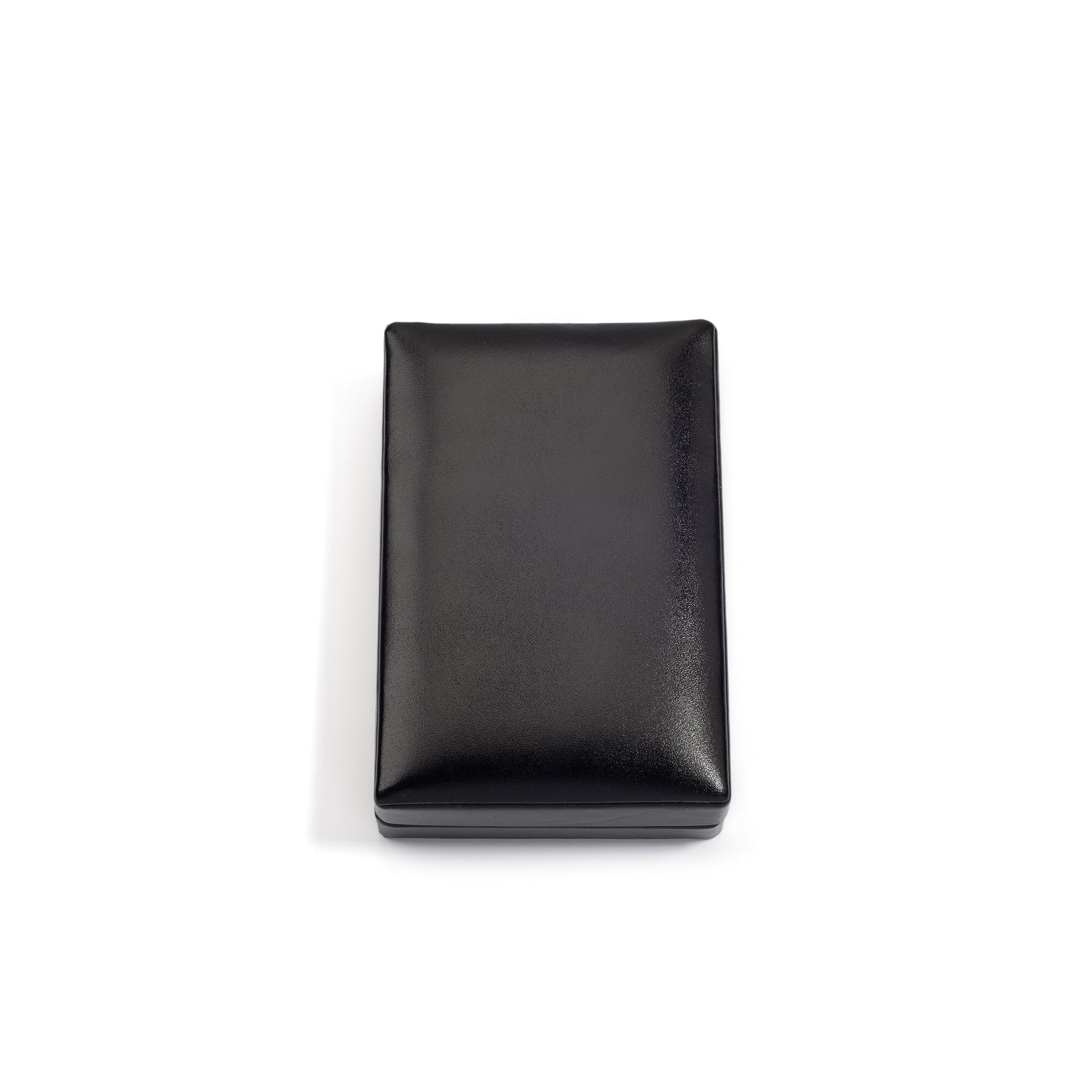 A closed, rectangular black jewelry box with a smooth, shiny surface, placed on a white background.