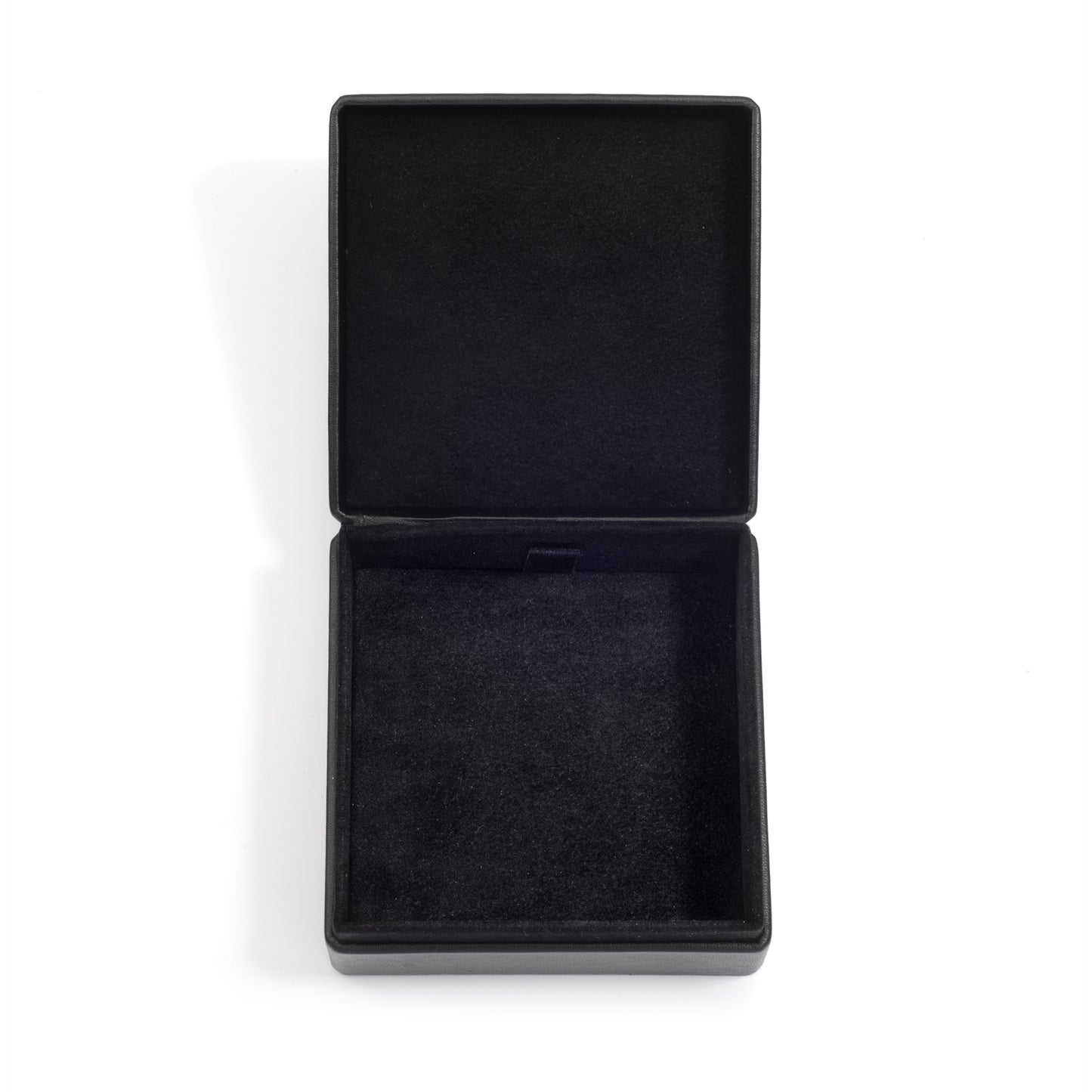 An open, empty black jewellery box with a soft black interior lining, displayed on a white surface.